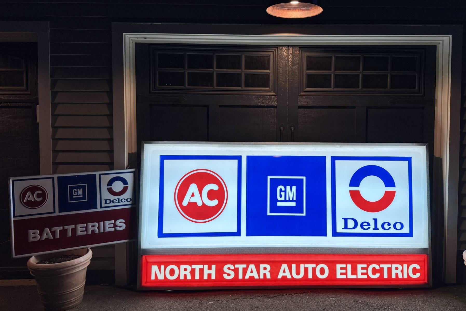 Pair of Single-Sided AC, General Motors, and Delco Signs